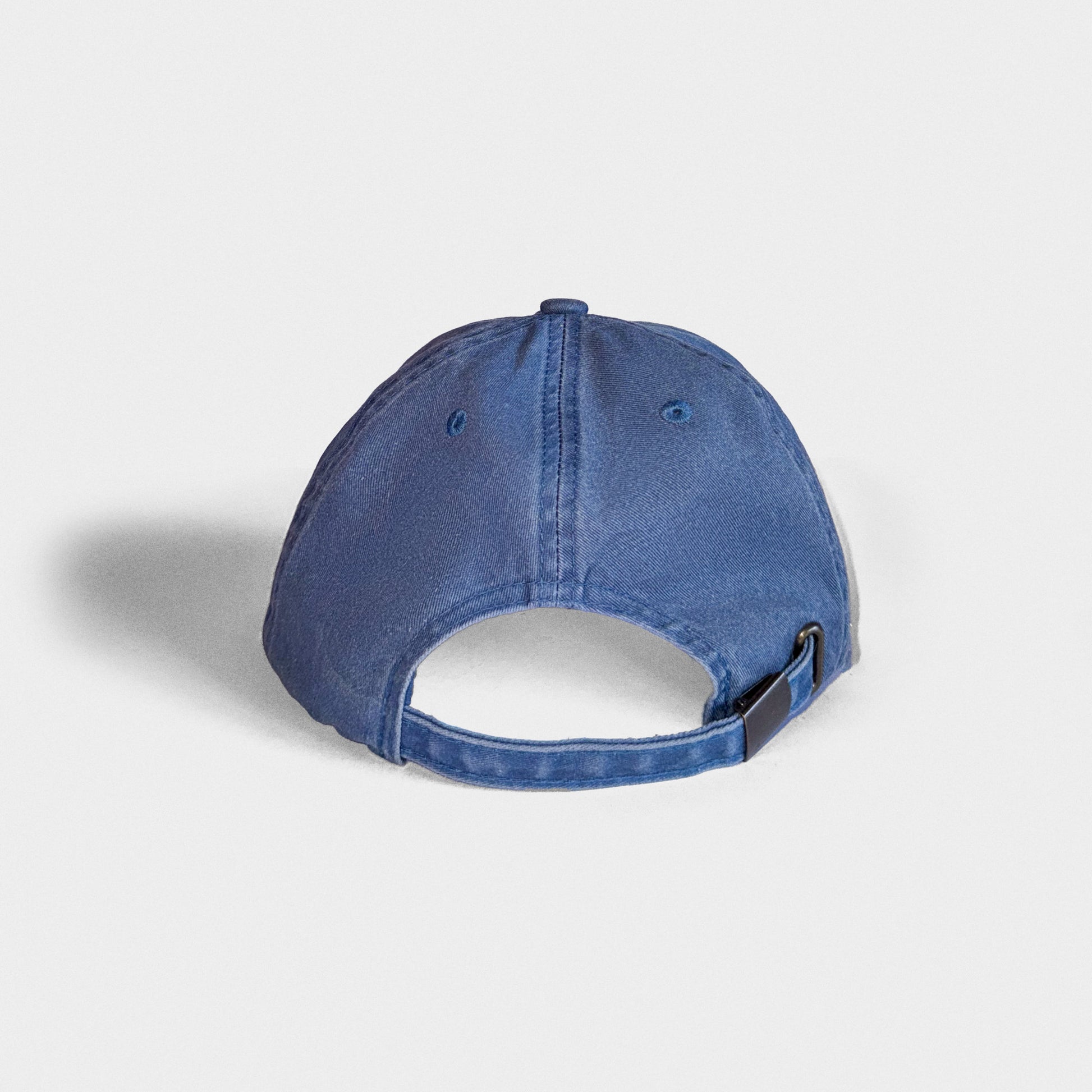 Back of a blue denim cap on a light gray background
