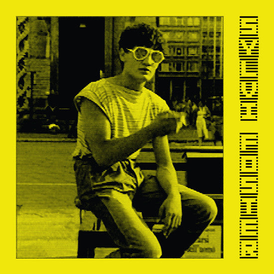 Person sitting on a bench with a yellow border and text on a black and white photo.